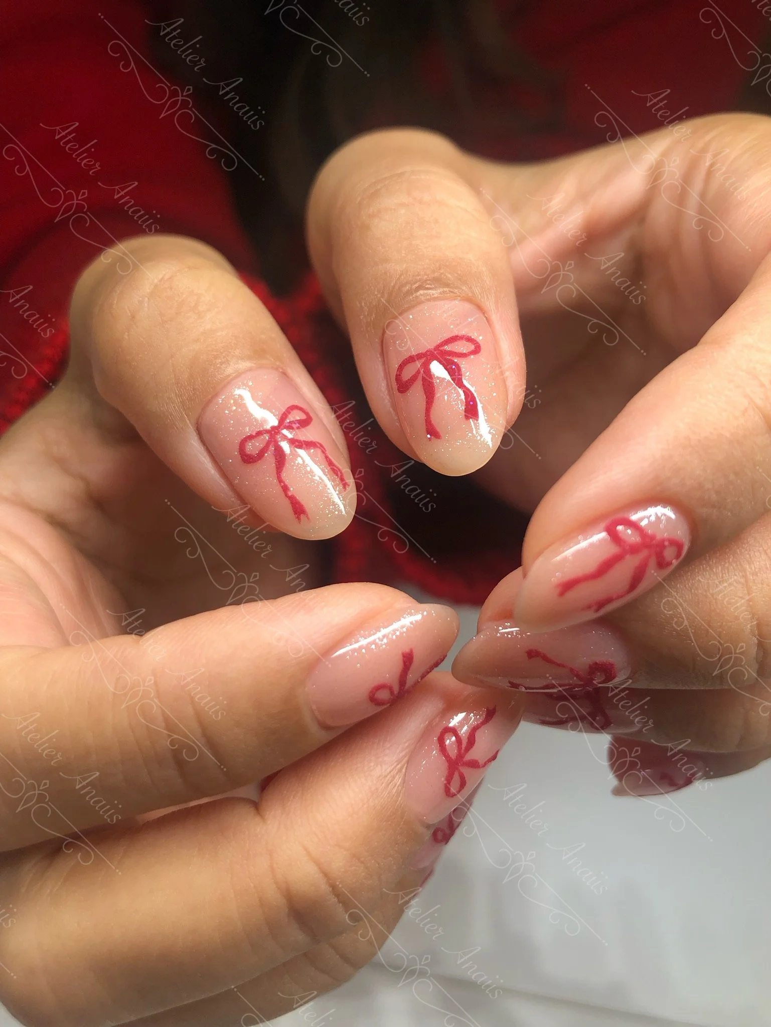 Hand drawn bows nail art on a custom blended pink nude gel polish on natural nails with chrome by Atelier Anaiis, a luxury nail salon in Old City, Philadelphia specializing in nail rehabilitation without E-files.
