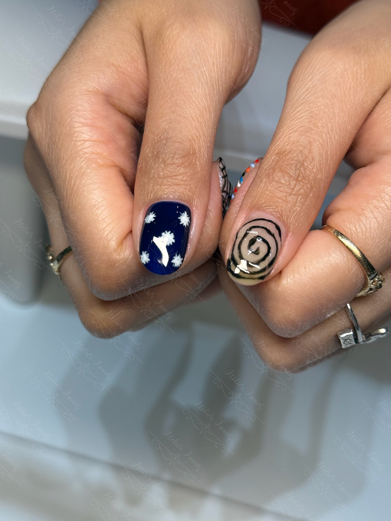 Fun abstract nail art on thumbs with swirl and star nail art at a nail salon in Old City.