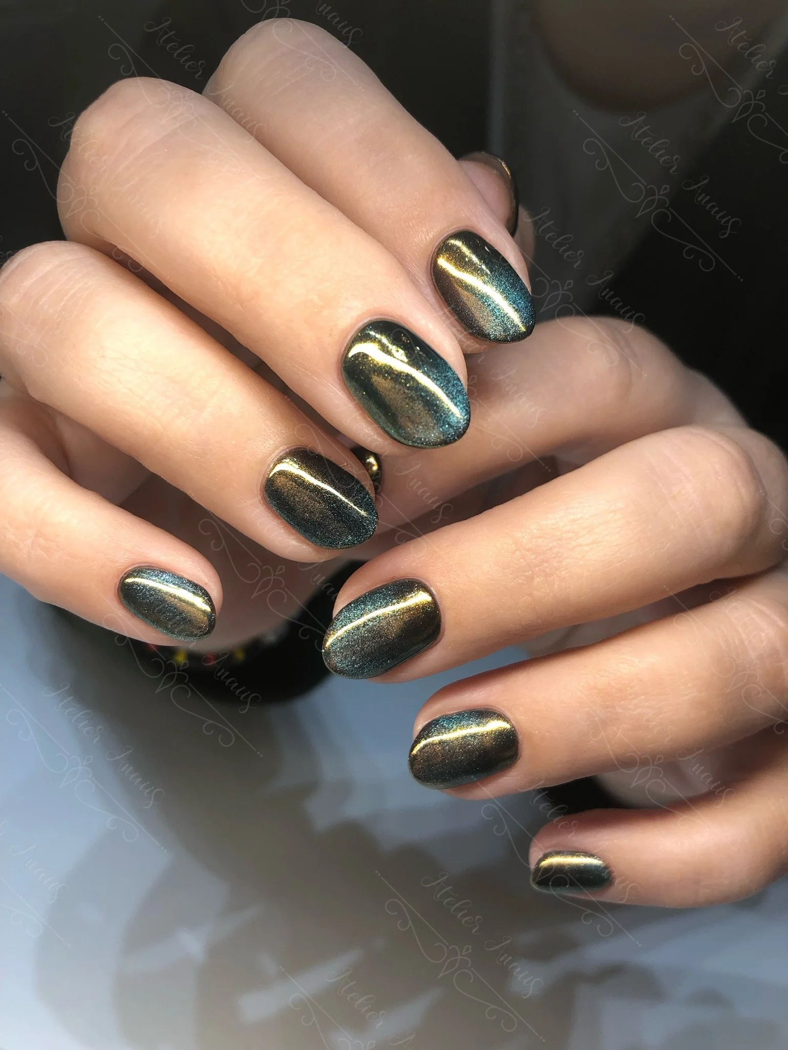 The Signature Foundation Manicure with a dark green metallic chrome gel polish on natural nails by Atelier Anaiis, a luxury nail salon in Old City, Philadelphia specializing in nail rehabilitation without E-files.