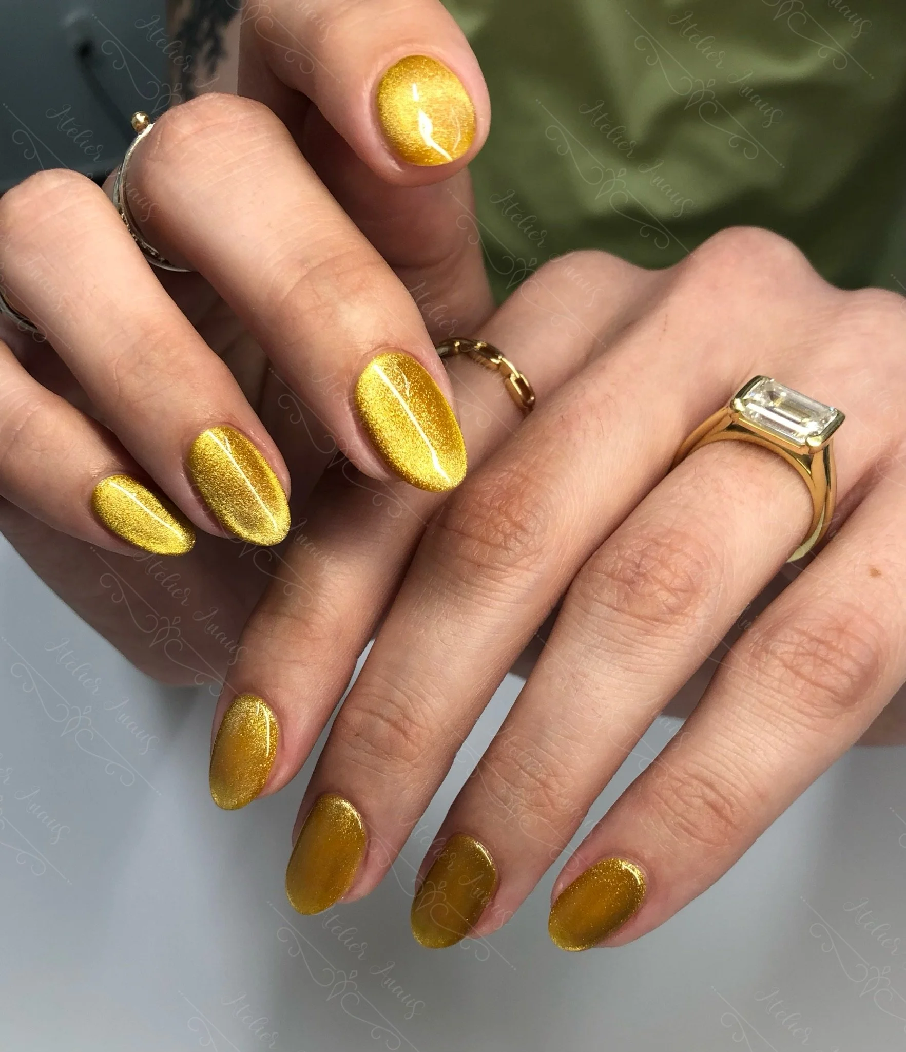 Medium nails featuring liquid gold yellow cat-eye velvet gel polish