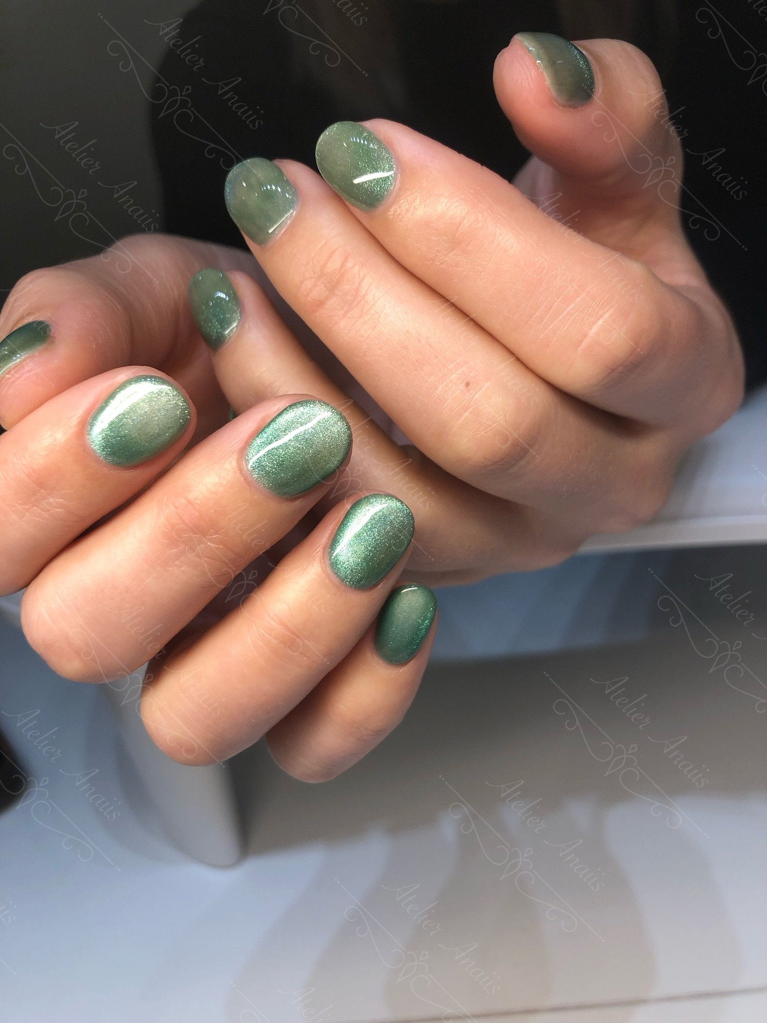 Short nails featuring soft olive green cat-eye velvet gel polish.