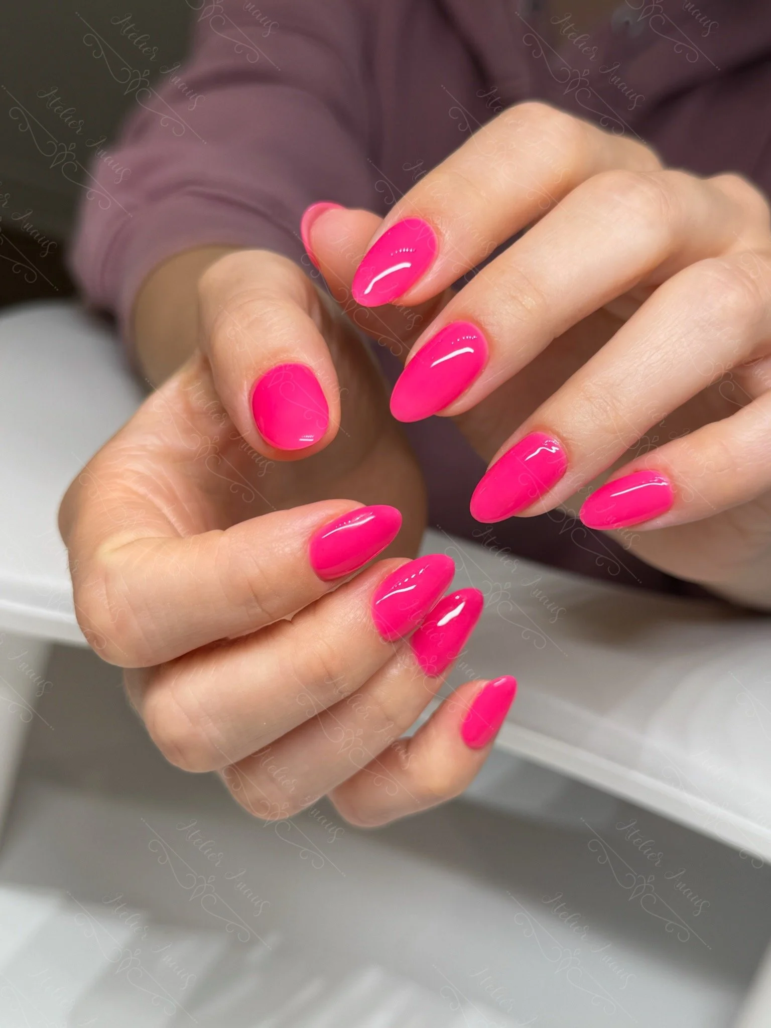 Fun neon pink vacation nails at a nail salon in Old City. 
