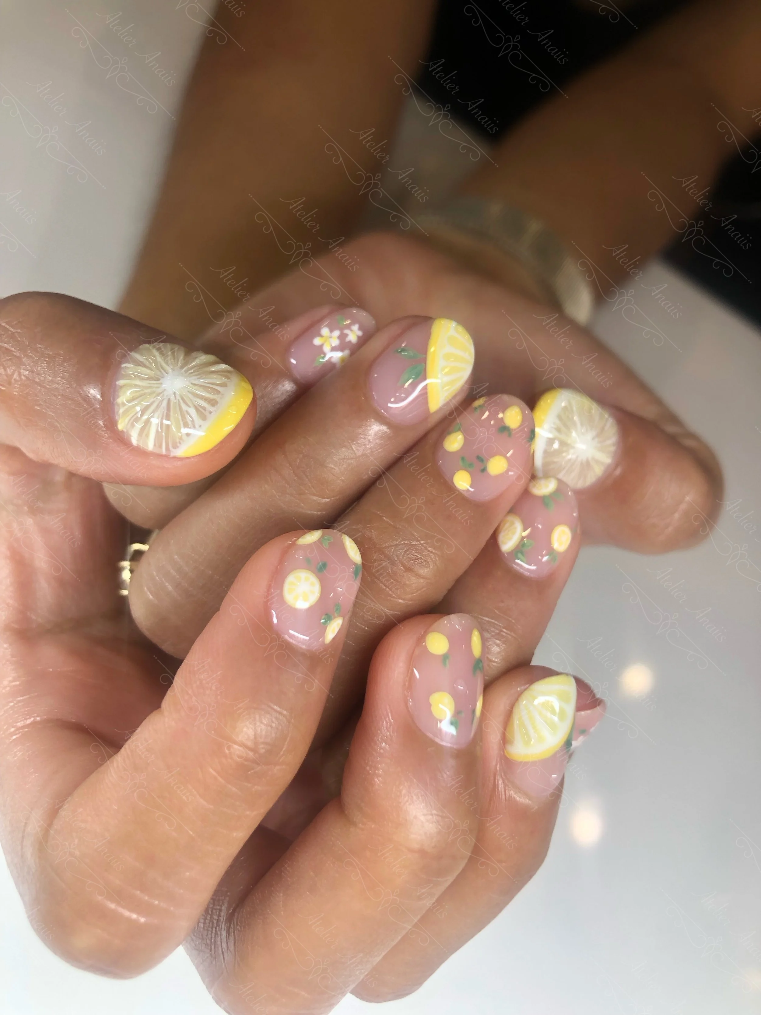 Hands featuring Intricate and fun Yellow Hand Drawn Lemons on Short Natural Nails