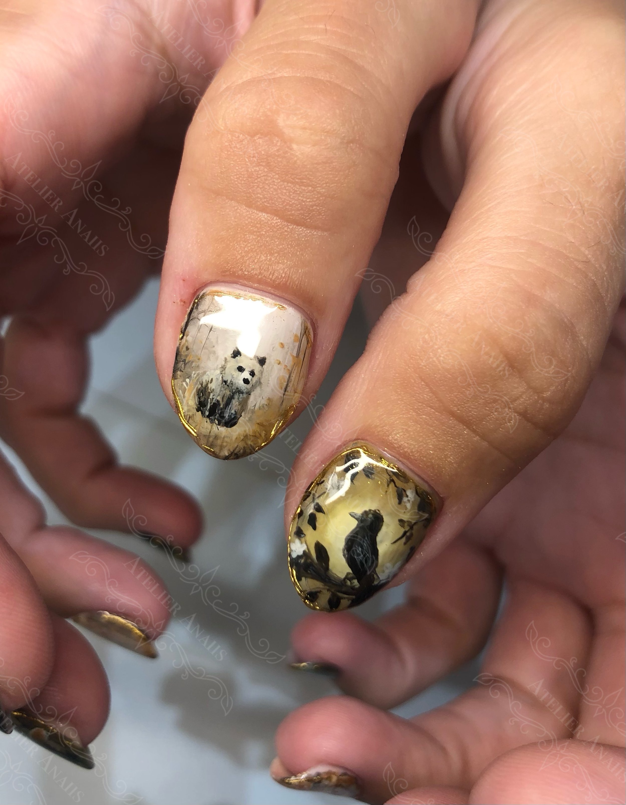 Thumb nails featuring Impressionist nail art of bear and crow in the forest.