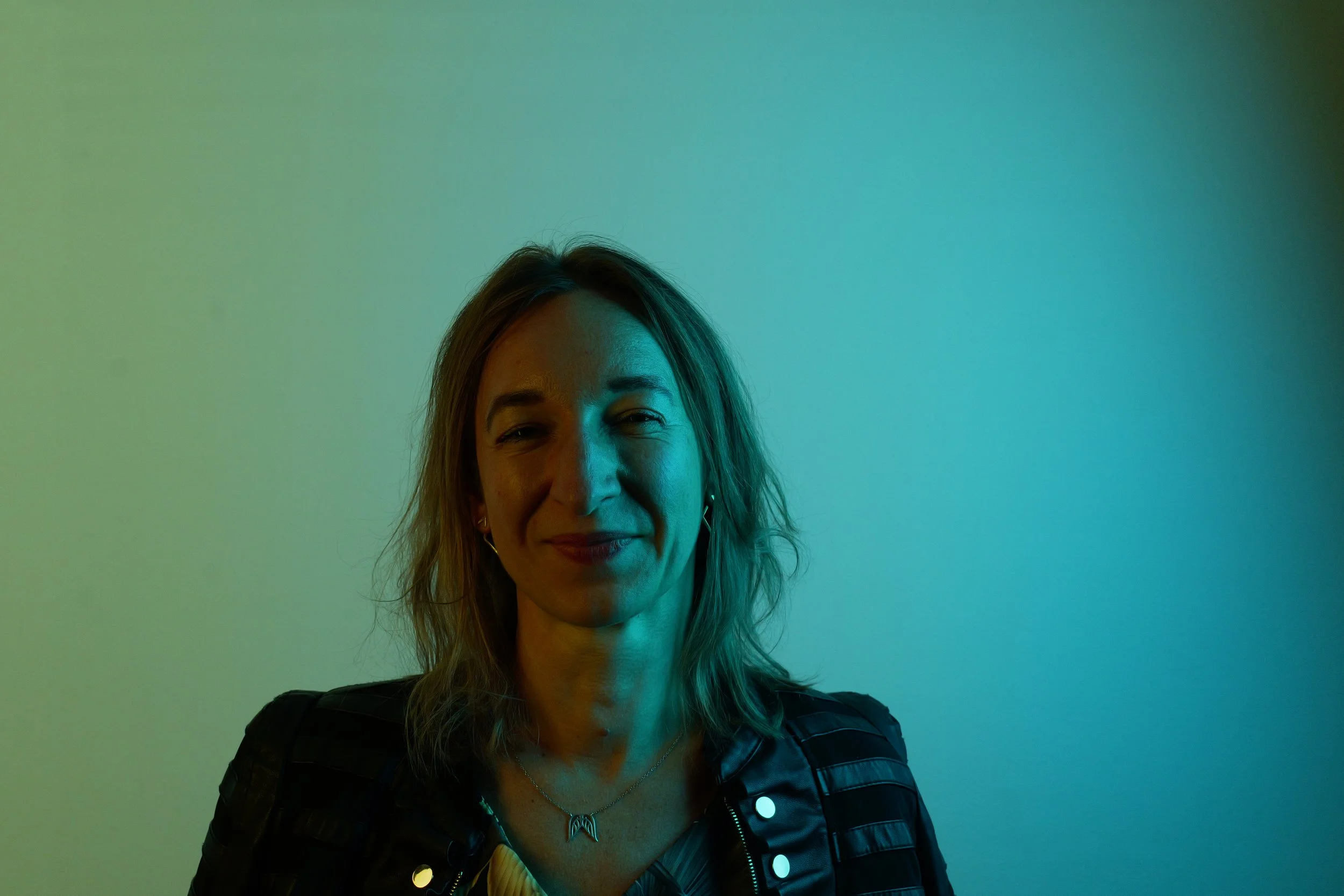 Portrait of Michaela Czernekova, an emotional eating coach and nutritionist based in Munich, Germany, smiling in her office.