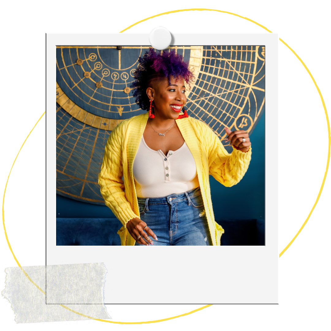 A woman, Dr. Mel Robinson-Brown, with purple and black curly hair, wearing a yellow cardigan, white top, and blue jeans, smiling and gesturing with her hand in front of a large nautical map or compass on the wall.
