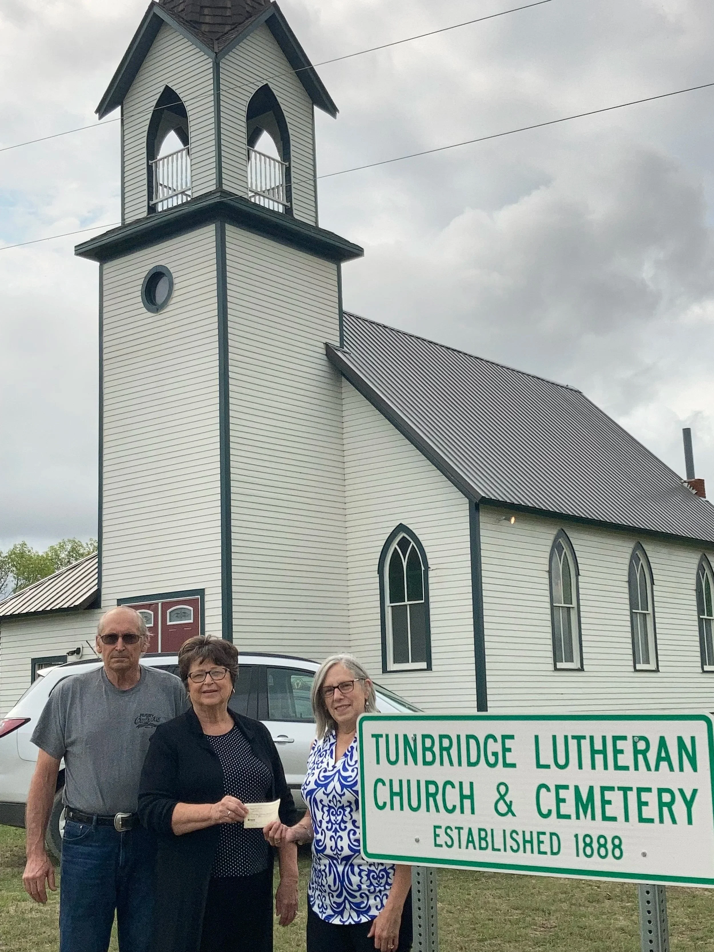 Accepting a donation to support restoration of Tunbridge Lutheran Church.