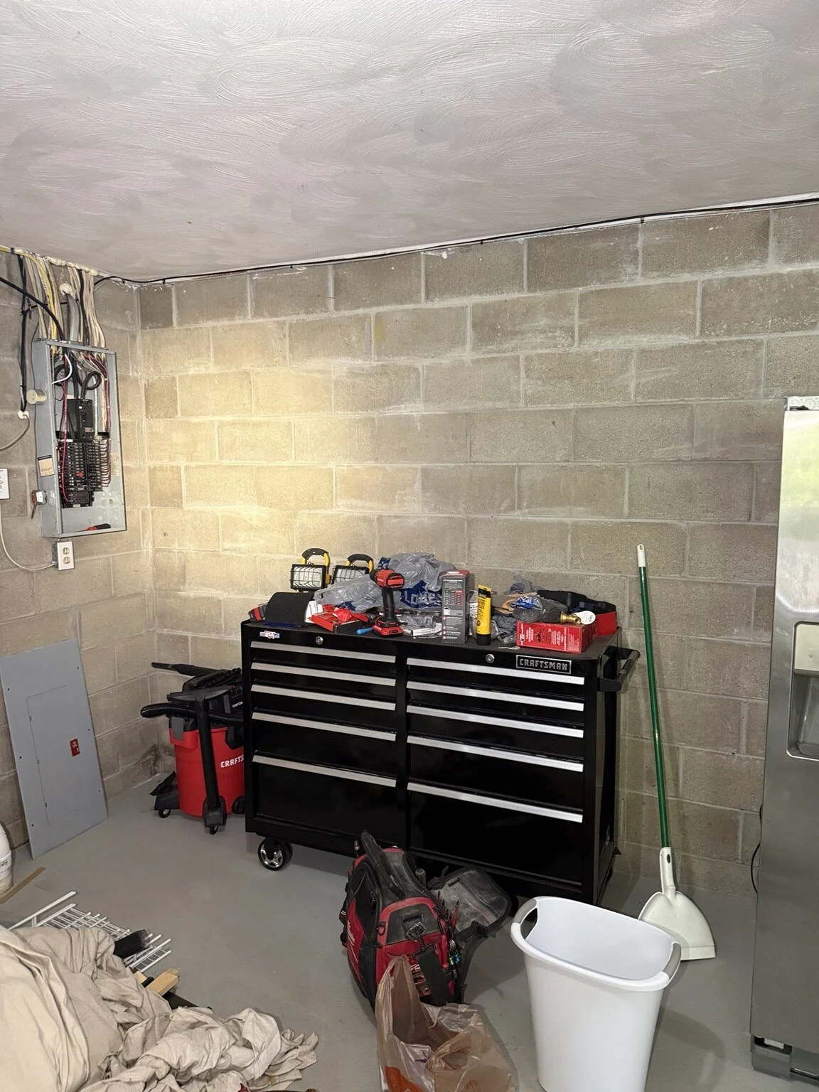 Before: Garage wall before installation of a new GFCI-protected receptacle circuit.