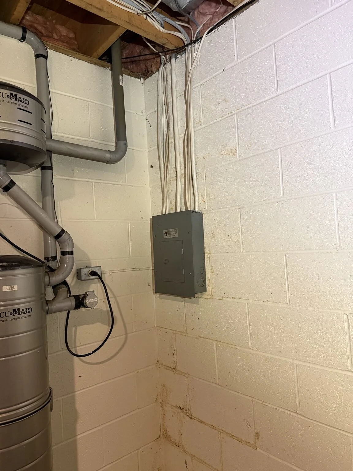 Outdated basement subpanel before replacement by JJM Electric