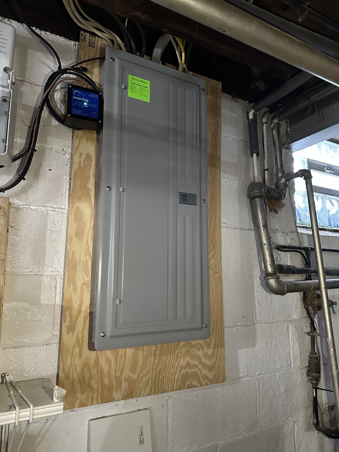 Finished 200-amp electrical panel with whole-house surge protection and inspection approval