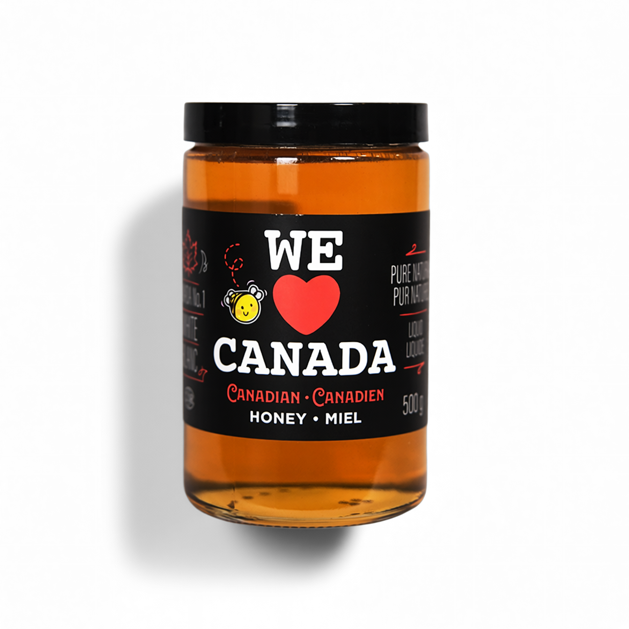 A jar of honey with a black label that says, 'We Heart Canada' and 'Canadian Honey' with a small cartoon bee illustration and red and white text.