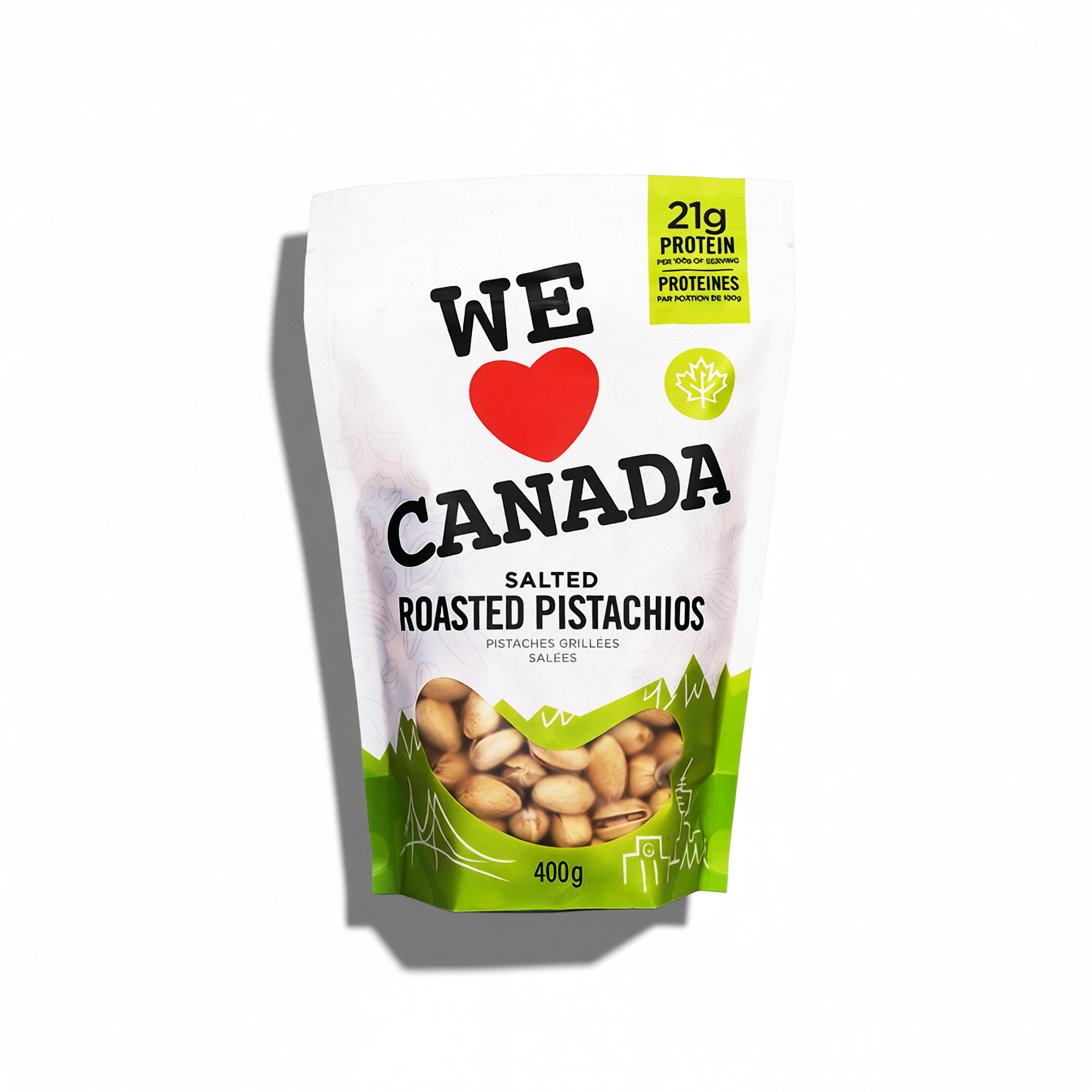 Package of salted roasted pistachios with a white and green design, featuring the text 'WE ♥ CANADA' and a red heart, with yellow and black accents highlighting 21g of protein per serving.
