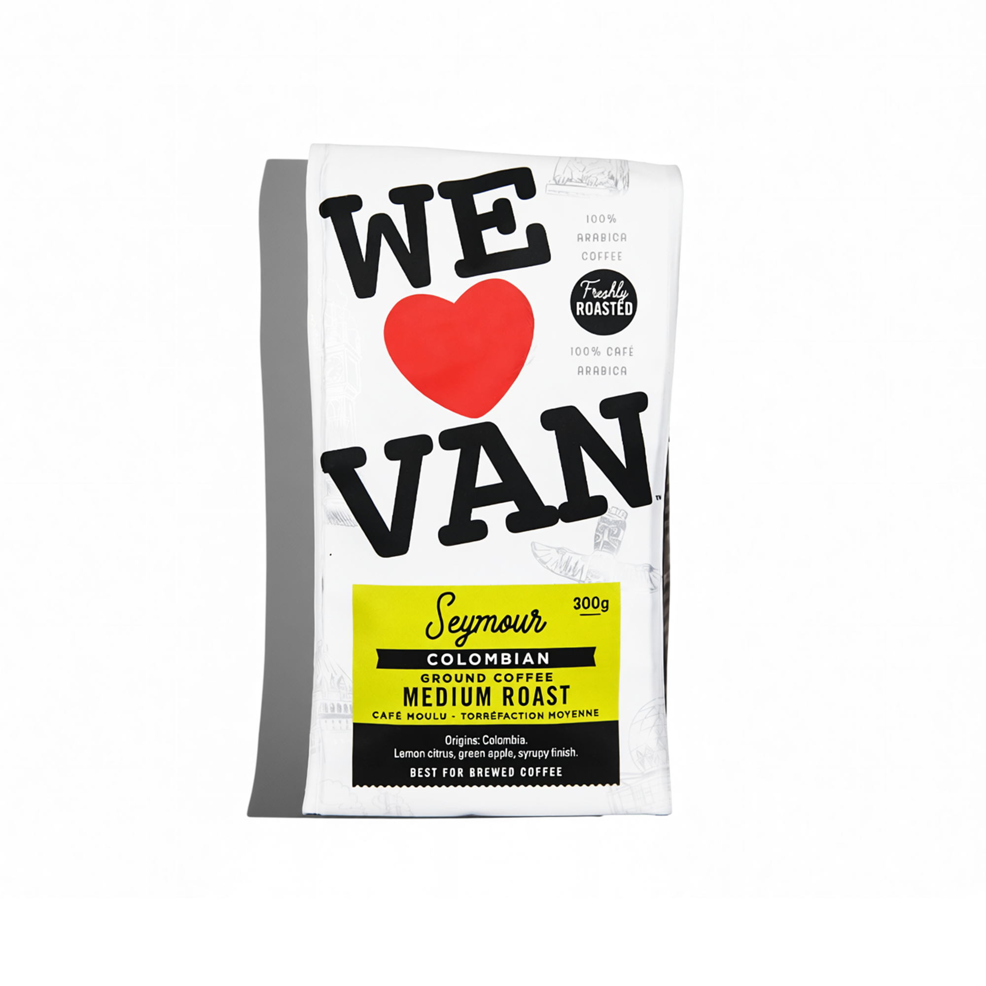 White coffee bag with black and red text, labeled 'WE ♥ VAN' and 'Seymour Colombian Ground Coffee Medium Roast 300g' with details about origins and flavor.