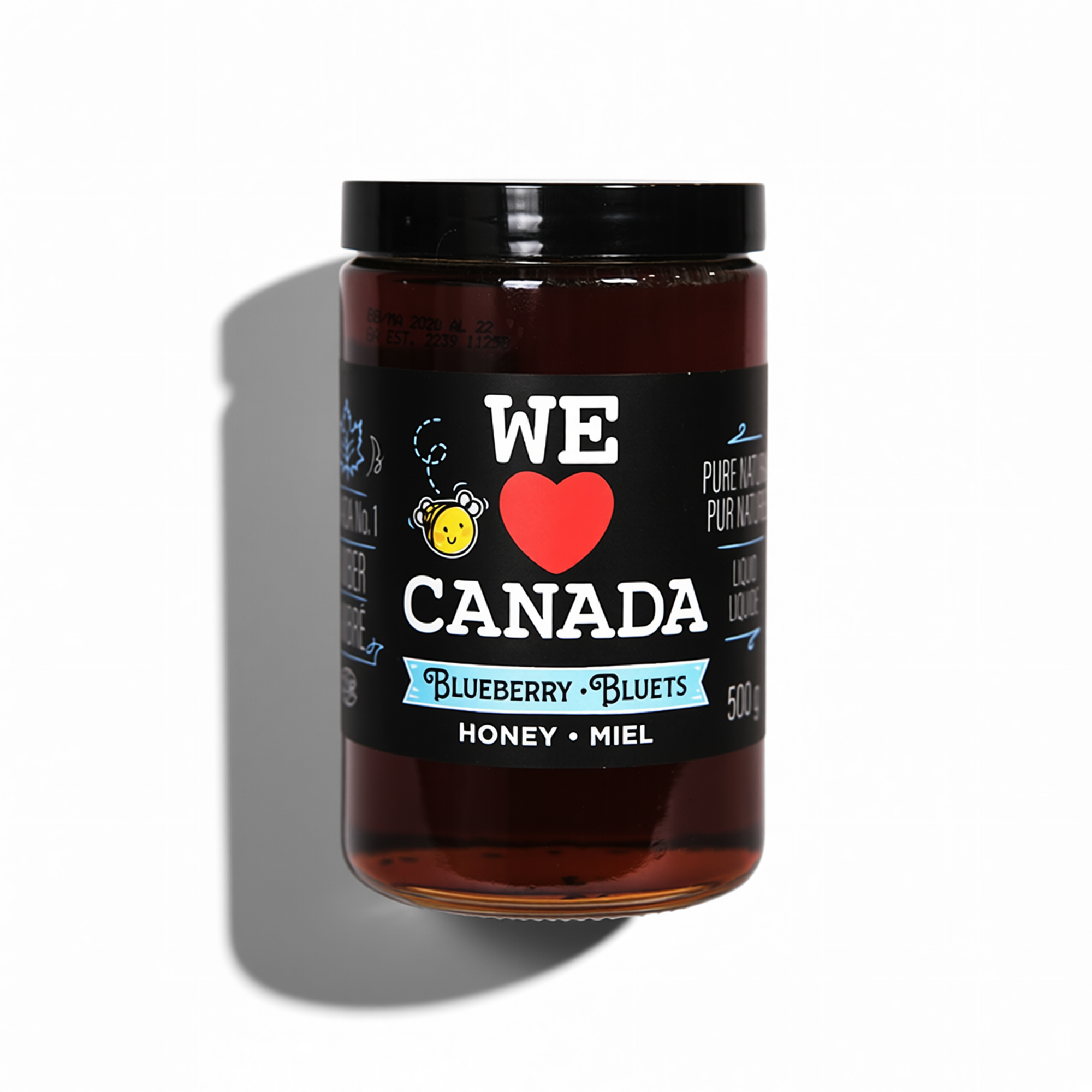 A jar of blueberry-bluets honey with a black label that says "We love Canada" with a red heart, and features blue and white accents and a yellow bear icon, on a white background.