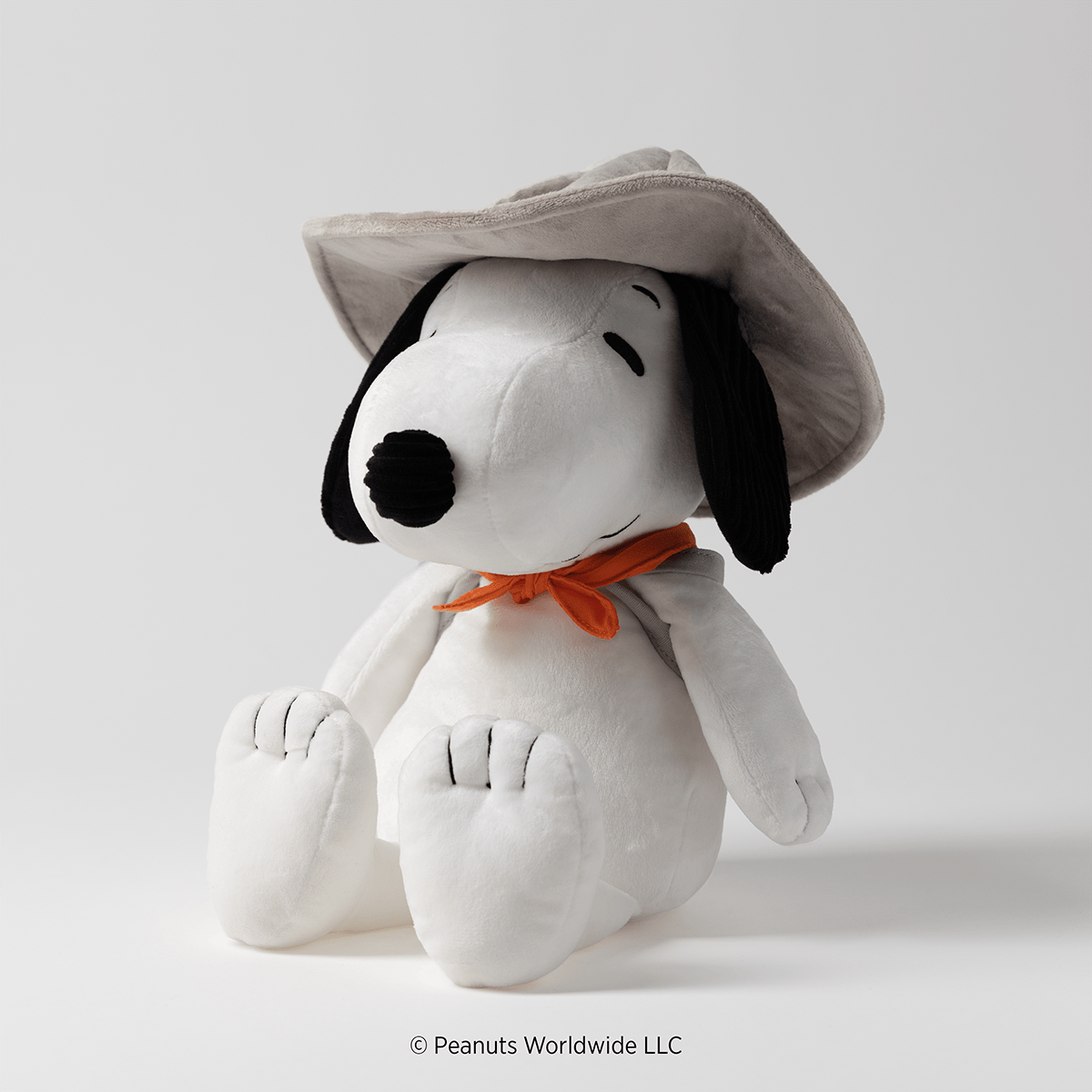 Snoopy Beagle Scouts Scentsy Buddy wearing a gray scout hat and orange neckerchief, shown in a seated side view