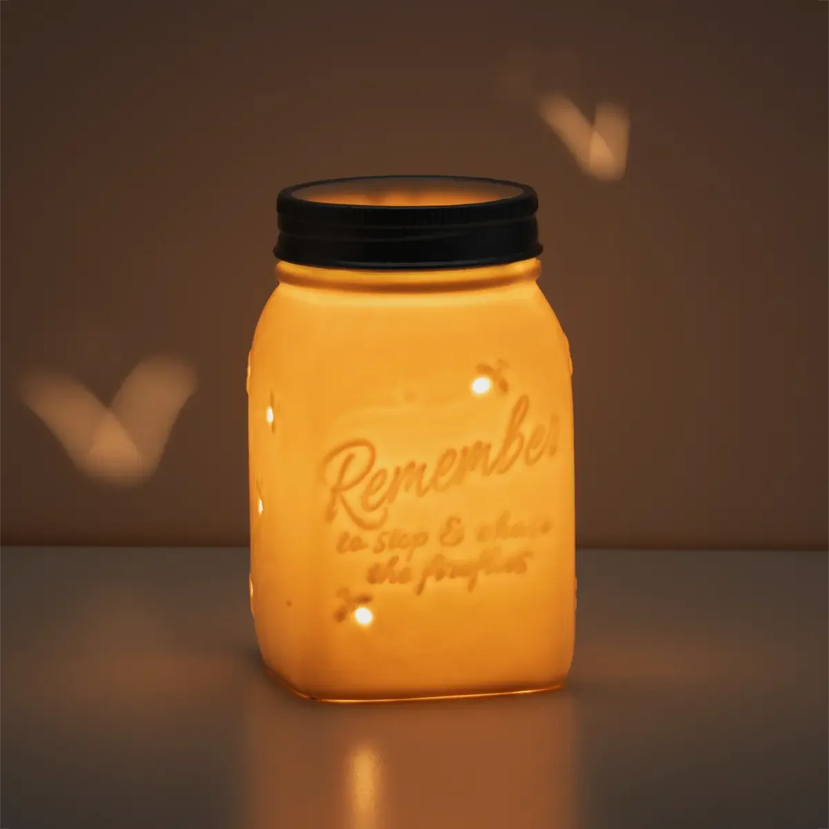 Chasing Fireflies Scentsy Warmer glowing softly in a dark room
