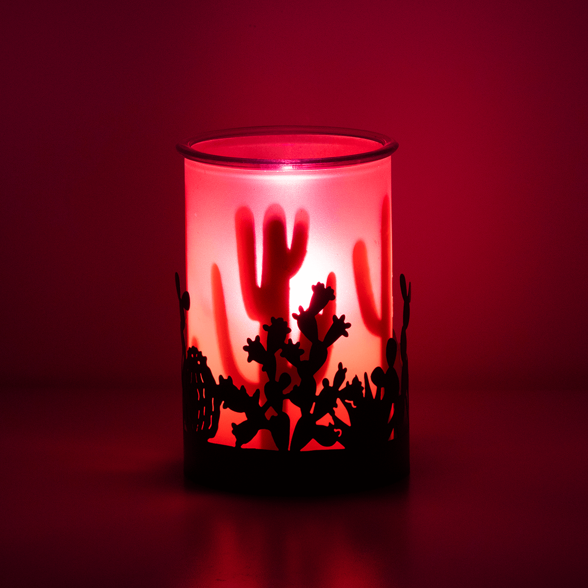 Mohave Scentsy Warmer illuminated with pink light creating desert-inspired shadows in a dark room