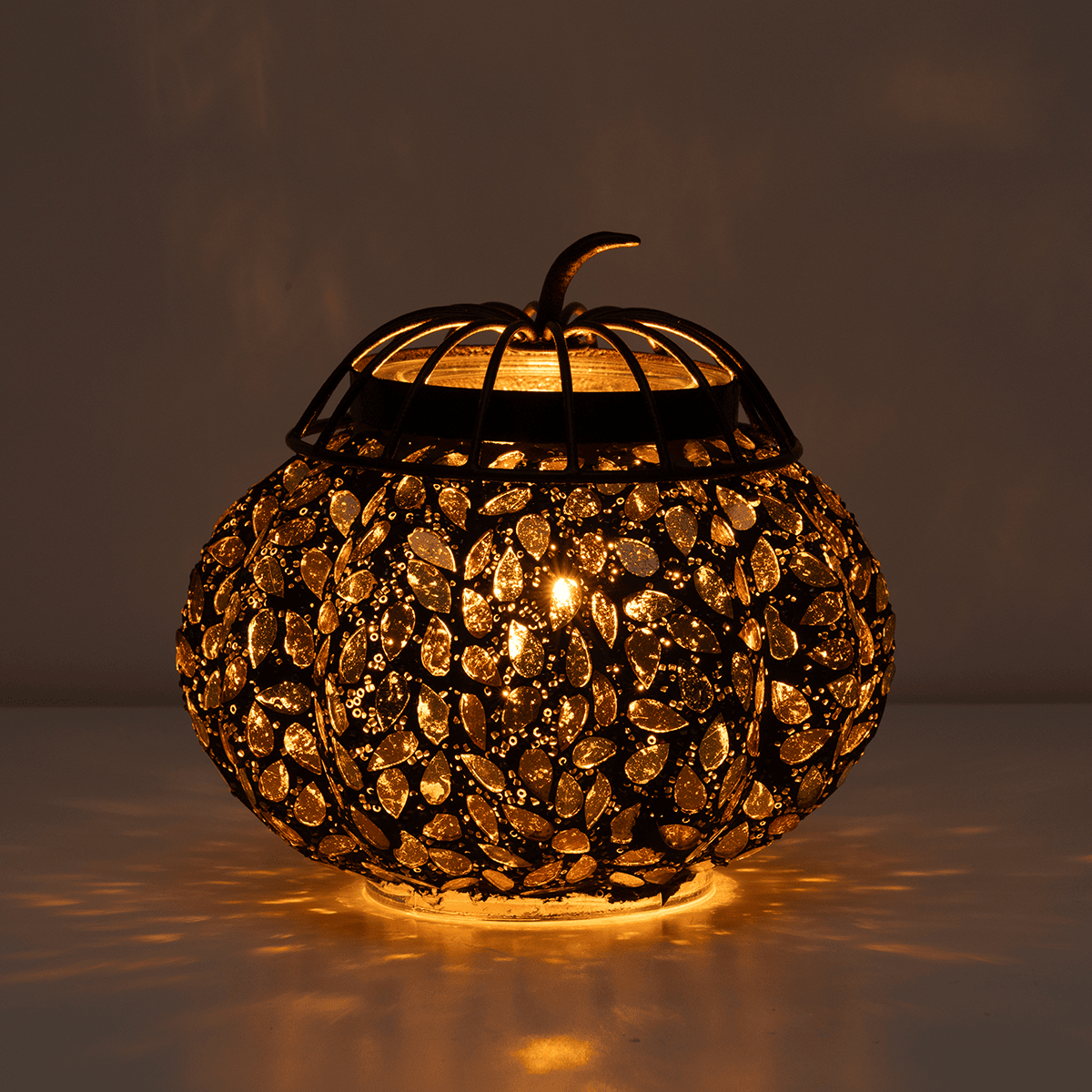 Golden Gourd Scentsy Warmer glowing warmly in a dark room