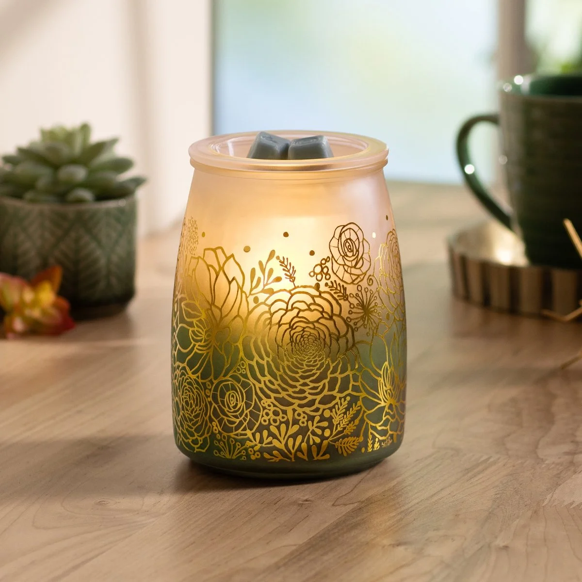 Tranquil Glow Scentsy Warmer styled in a bright room glowing with wax in the dish
