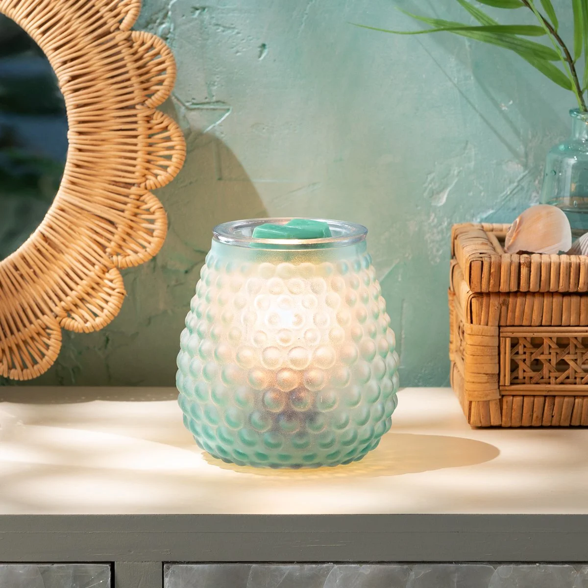 Bubble Blue Scentsy Warmer styled in a light, airy living space, glowing