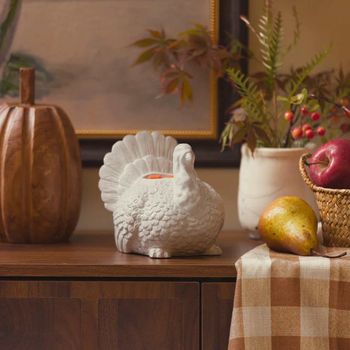 Scentsy Feathered Friend Warmer displayed with fall apples, pears and seasonal décor from the Harvest Collection