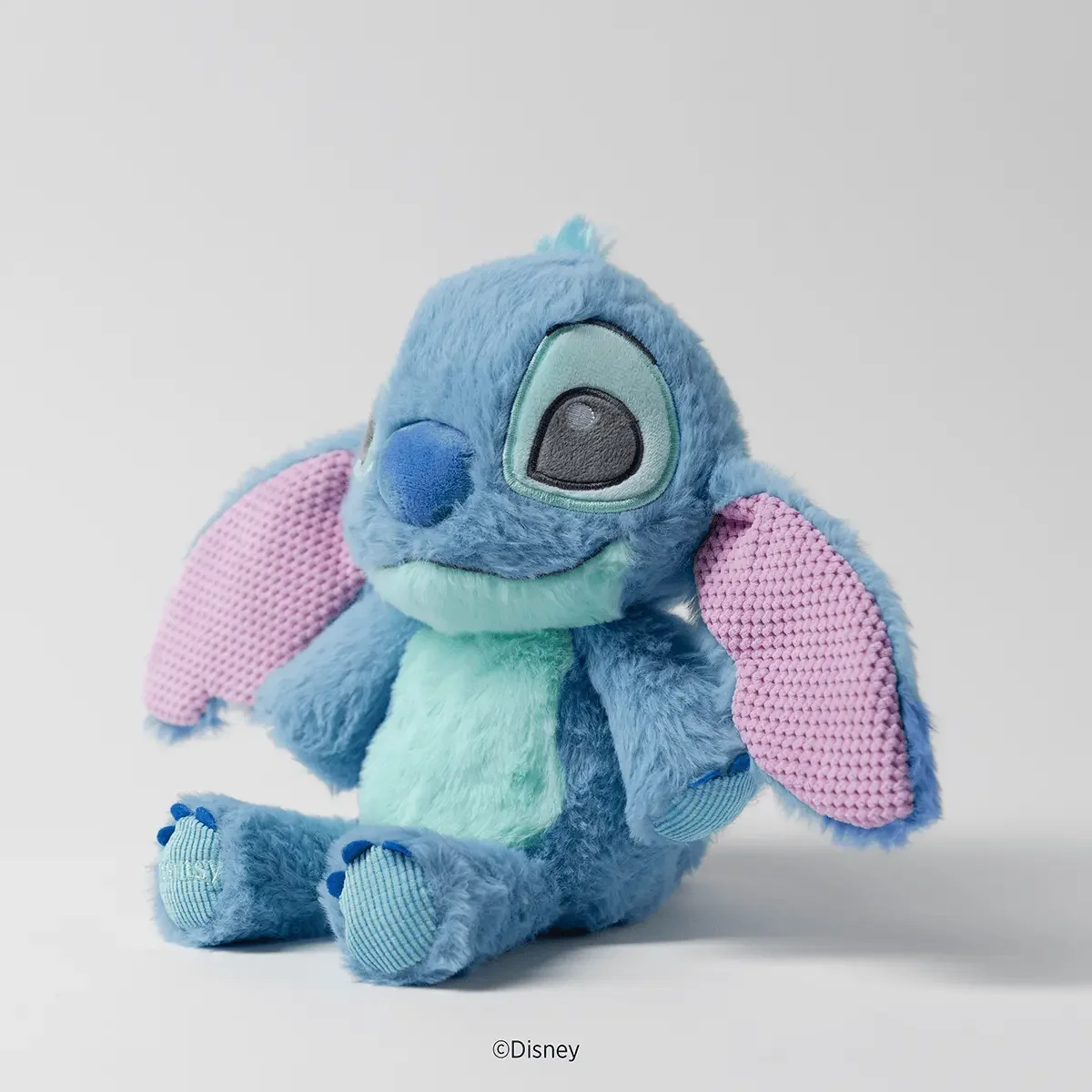 Side view of the Disney Stitch Scentsy Baby Buddy plush