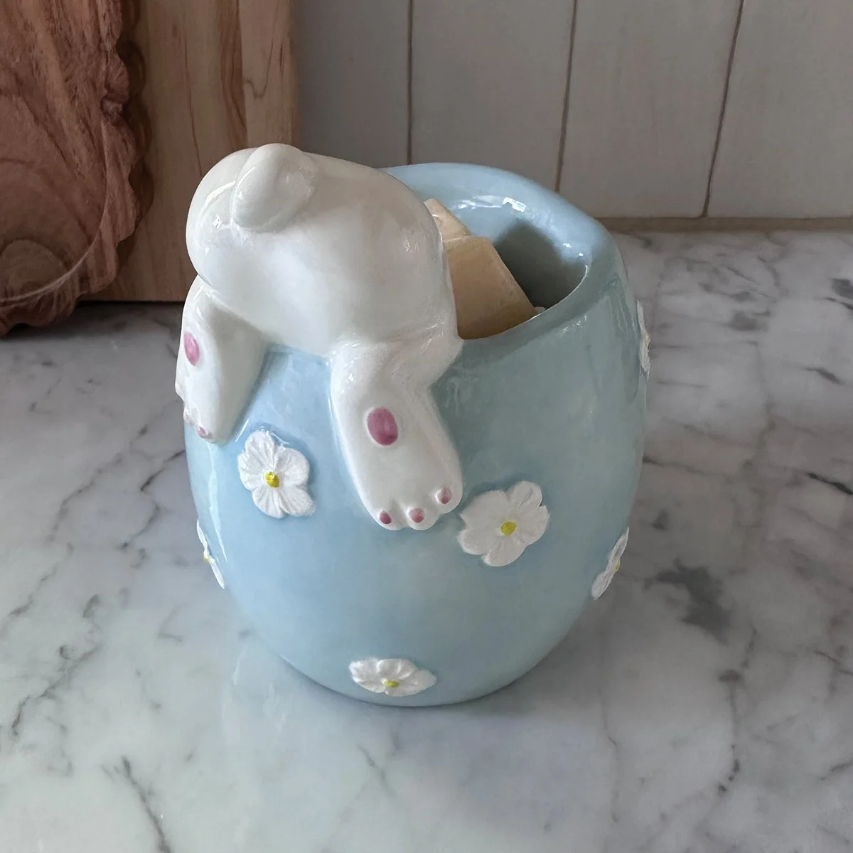 Curious Cottontail Scentsy Warmer styled on a table showing top view of the bunnies bum