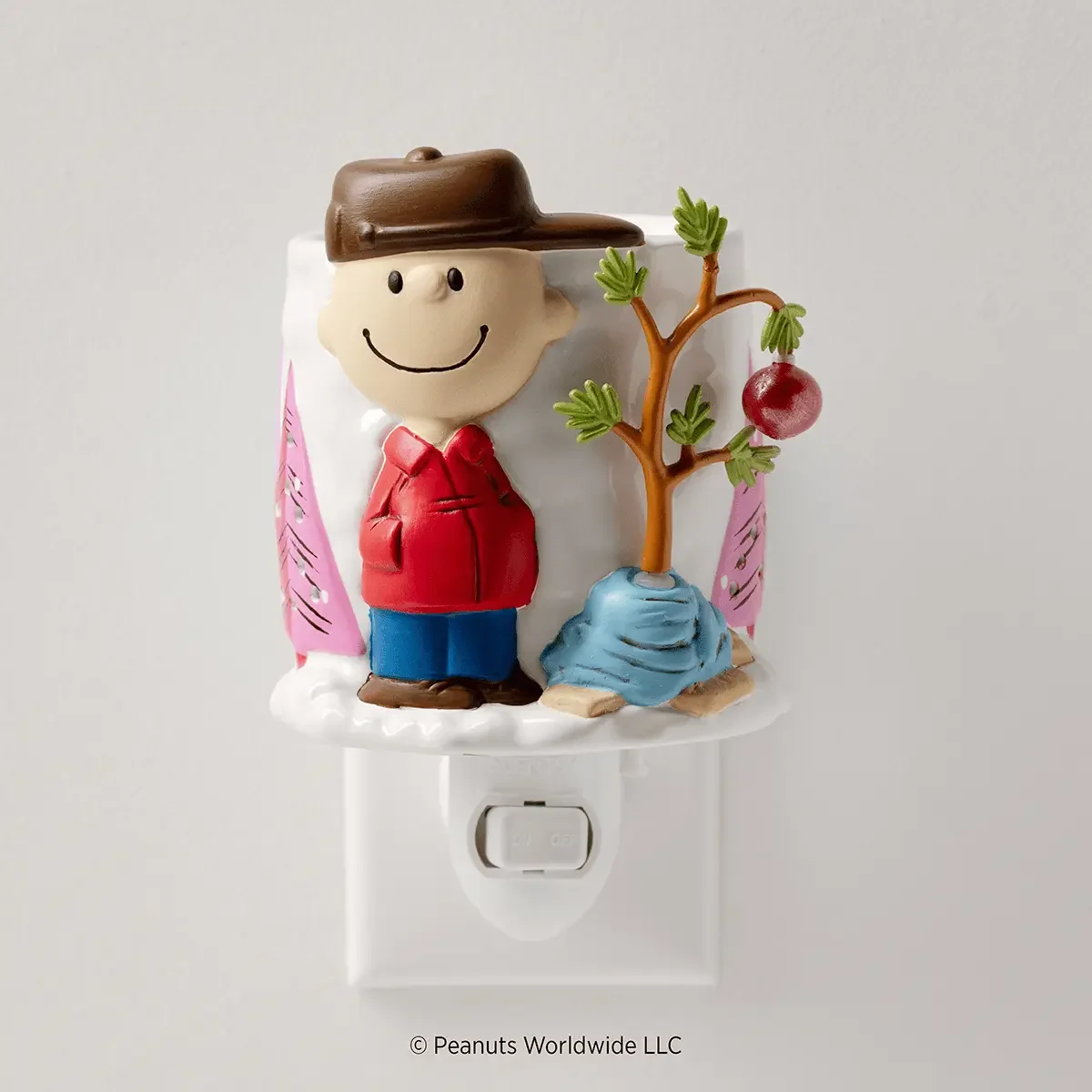 Peanuts A Charlie Brown Christmas Scentsy Mini Warmer featuring Charlie Brown standing beside his small Christmas tree wrapped in a blue blanket, with pink trees in the background