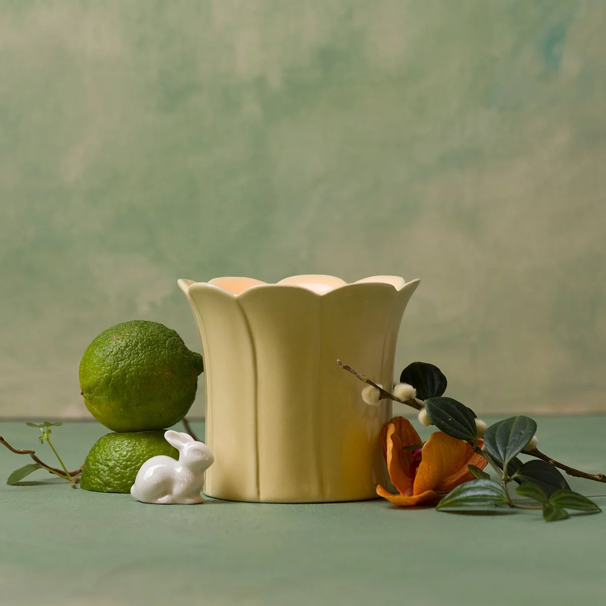 The Wild Honeysuckle & Willow 10 oz Scentsy Candle from the 2026 Easter Collection is styled with fresh greenery, citrus and soft seasonal accents