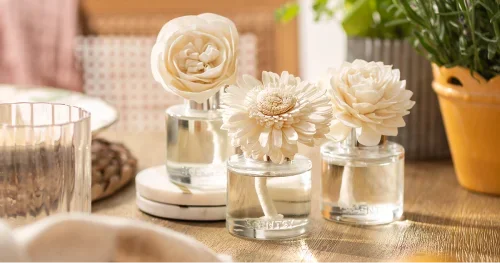 Three Scentsy Fragrance Flowers in glass bottles providing decorative, flameless home fragrance