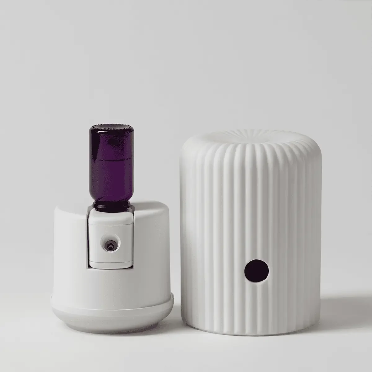 Scentsy Solo Diffuser with a fragrance cartridge showing the inside and sitting in a couple of pieces