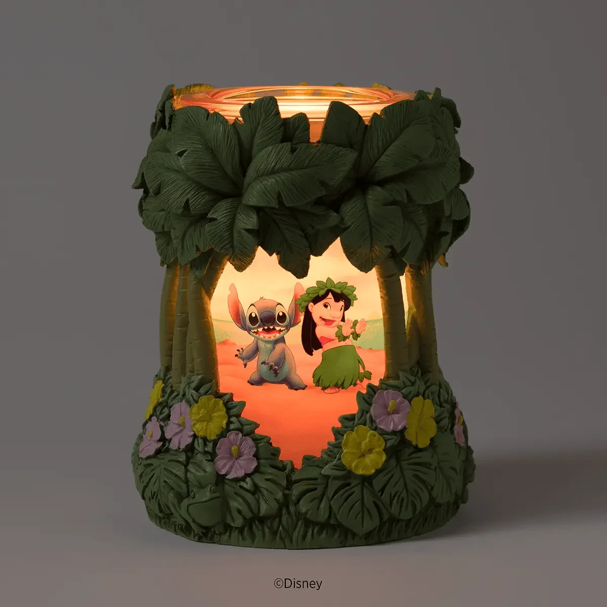 Disney Lilo & Stitch Aloha-Ohana Scentsy Warmer illuminated in a dark room with a tropical Lilo and Stitch scene