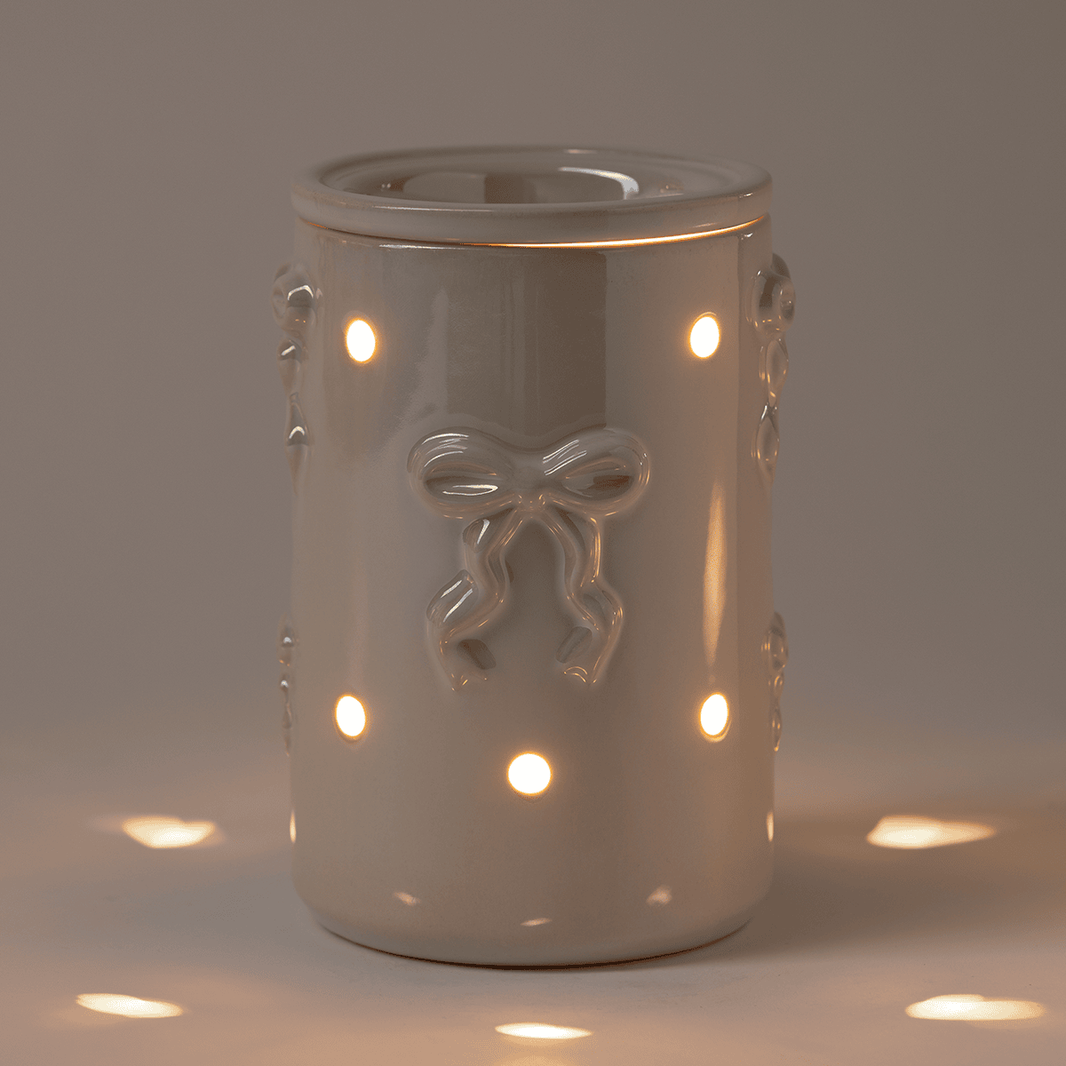 Dreamer's Bow Scentsy Warmer in a Dark Room glowing