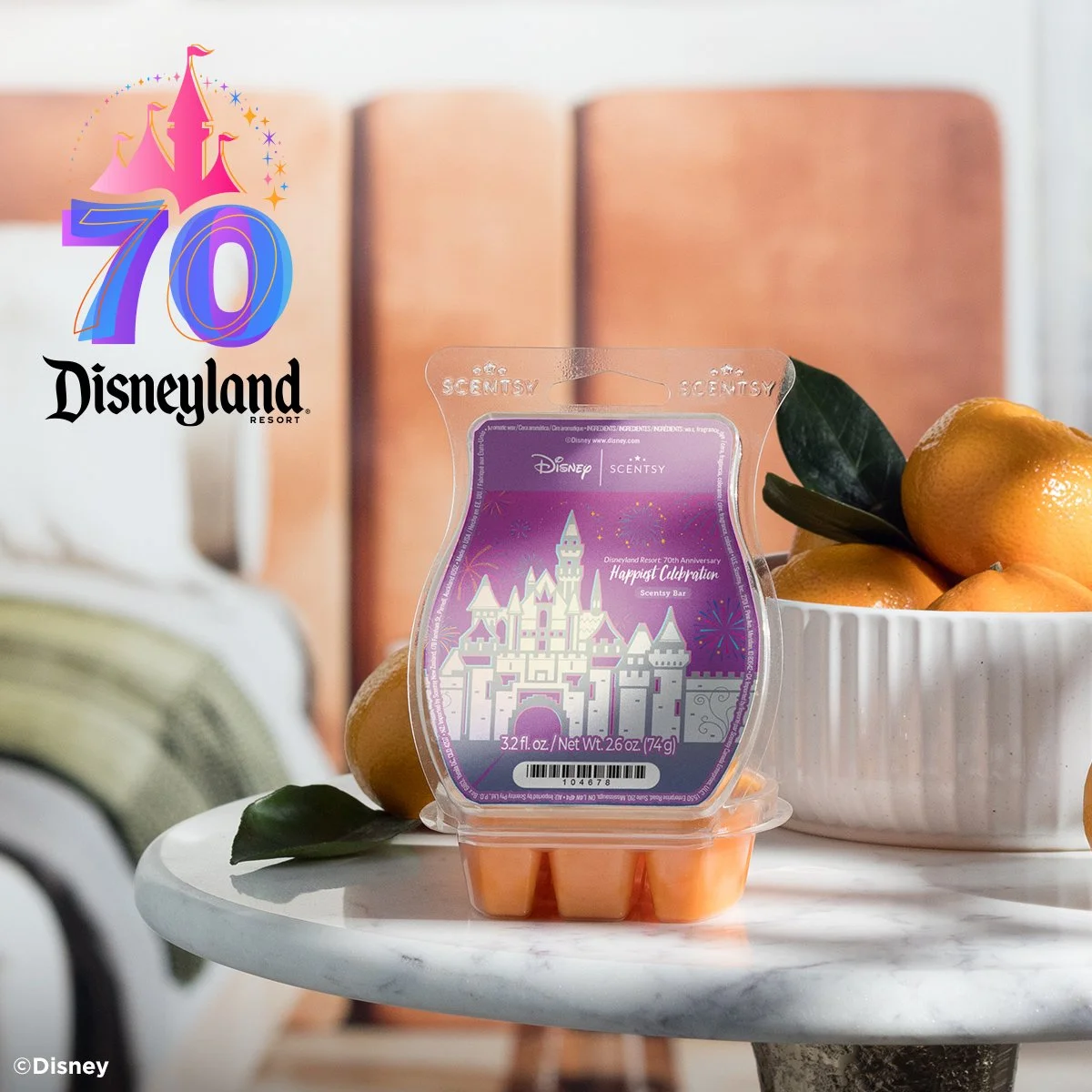 The Happiest Celebration Scentsy Wax Bar from the Disneyland Resort 70th Anniversary Celebration, styled with fresh citrus accents to reflect the bright notes of orange blossom, coconut, and vanilla sugar.