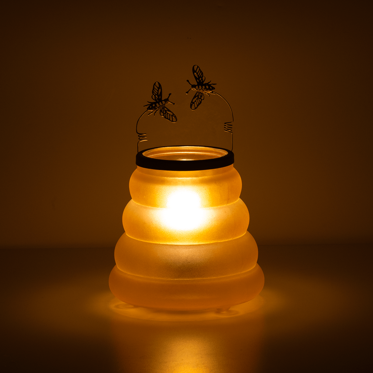 Beehive Scentsy Warmer styled in a dark room glowing