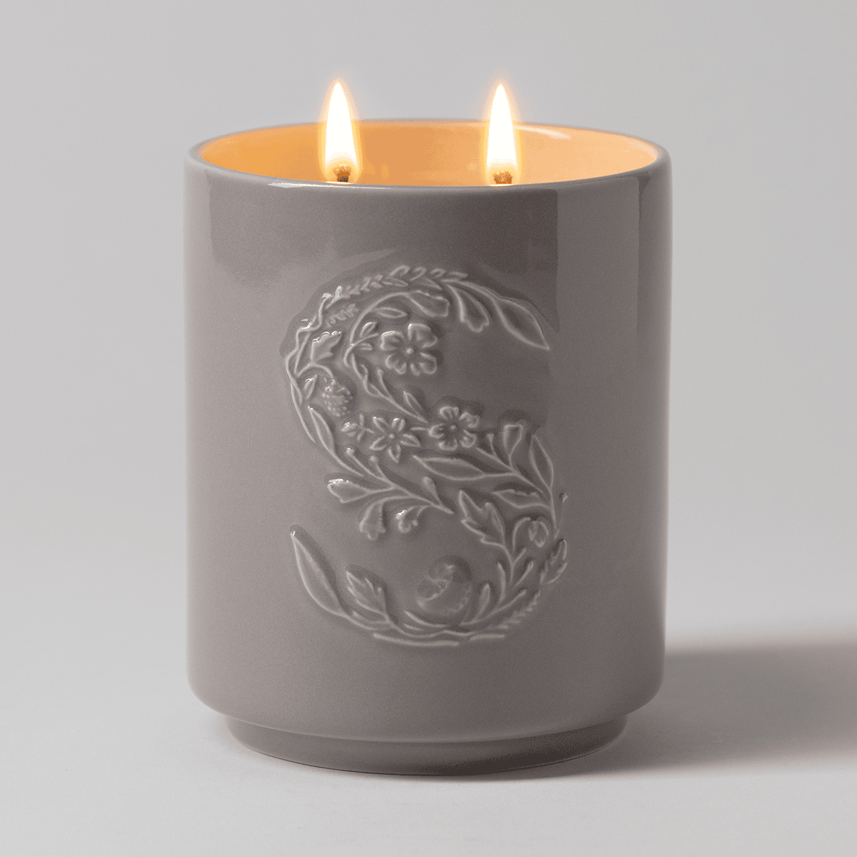 Cocoa Cashmere Scentsy Candle lit with glowing wicks creating a warm, luxurious ambiance