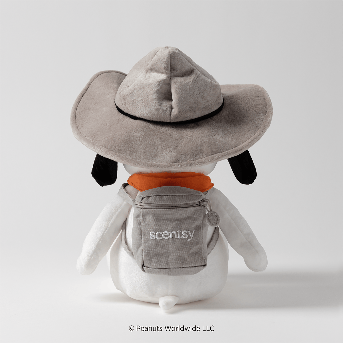 Back view of the Snoopy Beagle Scouts Scentsy Buddy showing the attached gray backpack and scout hat