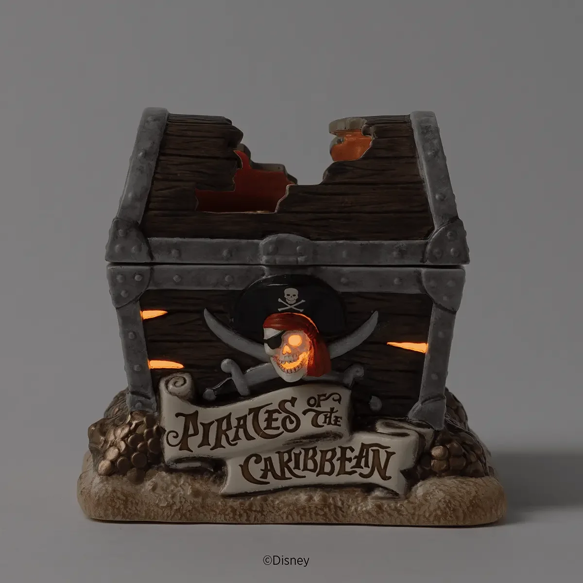 Disney Pirates of the Caribbean Scentsy Warmer glowing in low light through the skull and treasure chest