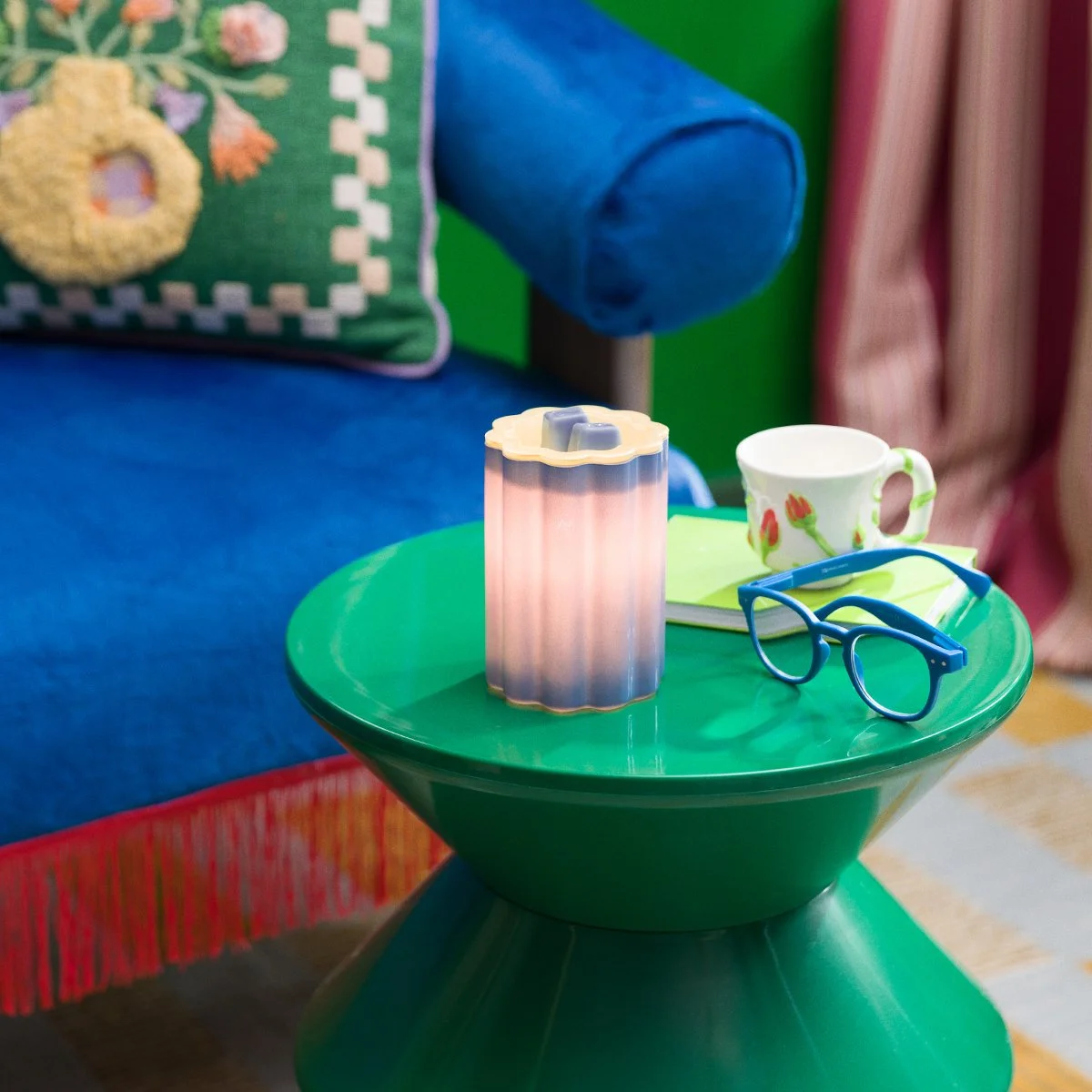 Blue Bloomie wax warmer illuminated to reveal rich blue colour and playful floral textures, designed to energize modern home décor.