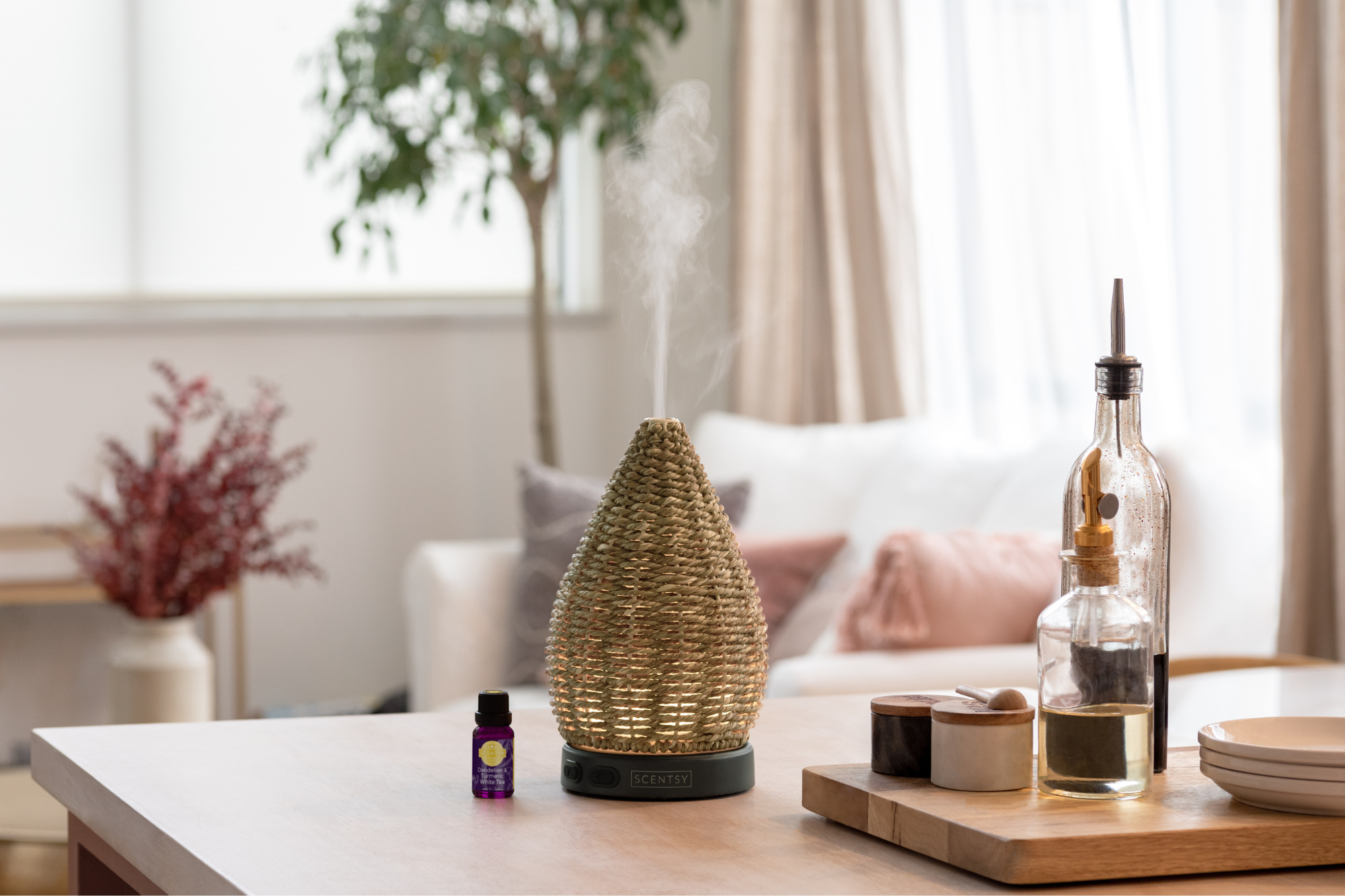 Scentsy essential oil diffuser releasing a soft mist in a modern, neutral living space