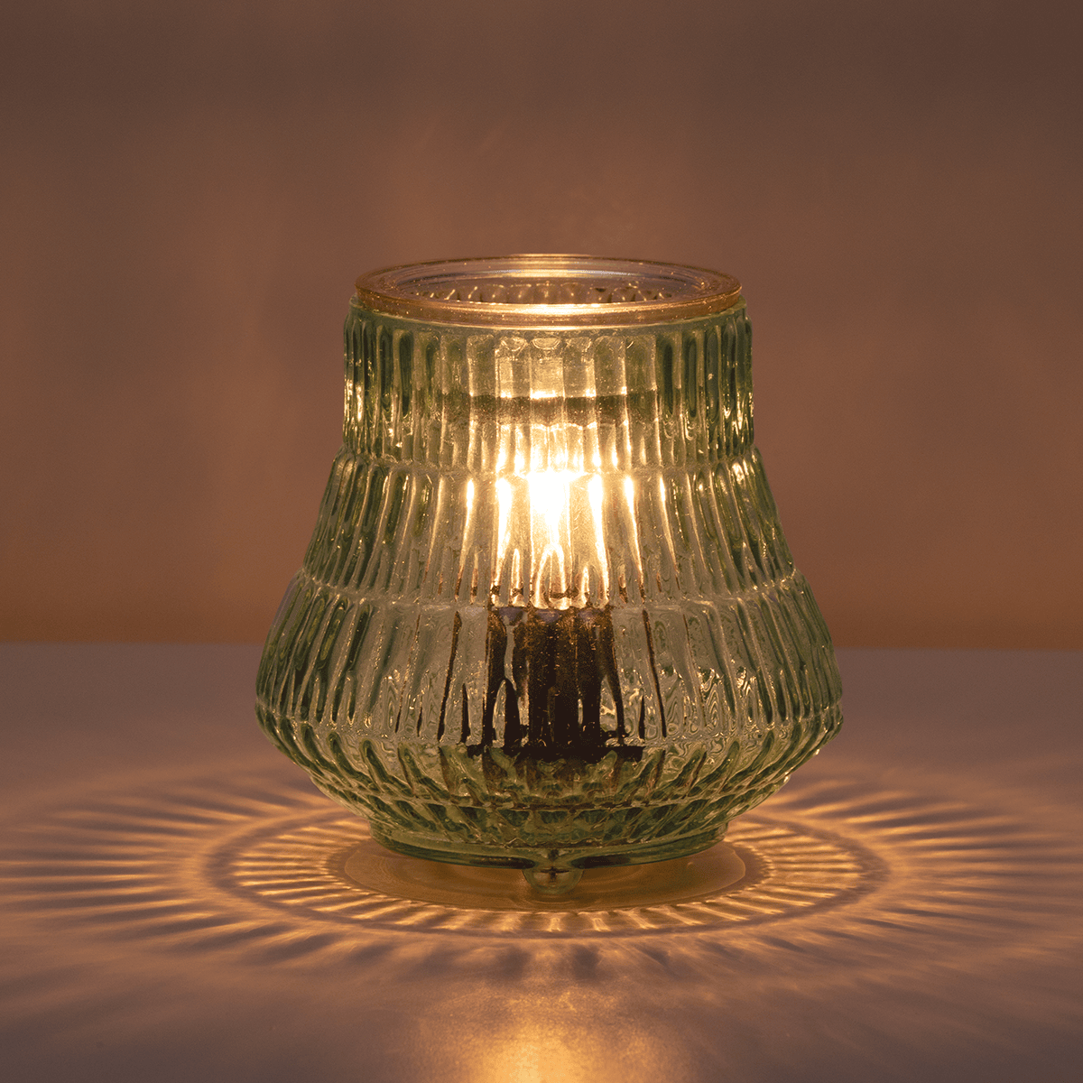 Moroccan Mint Scentsy Warmer styled in a dark room glowing and casting light