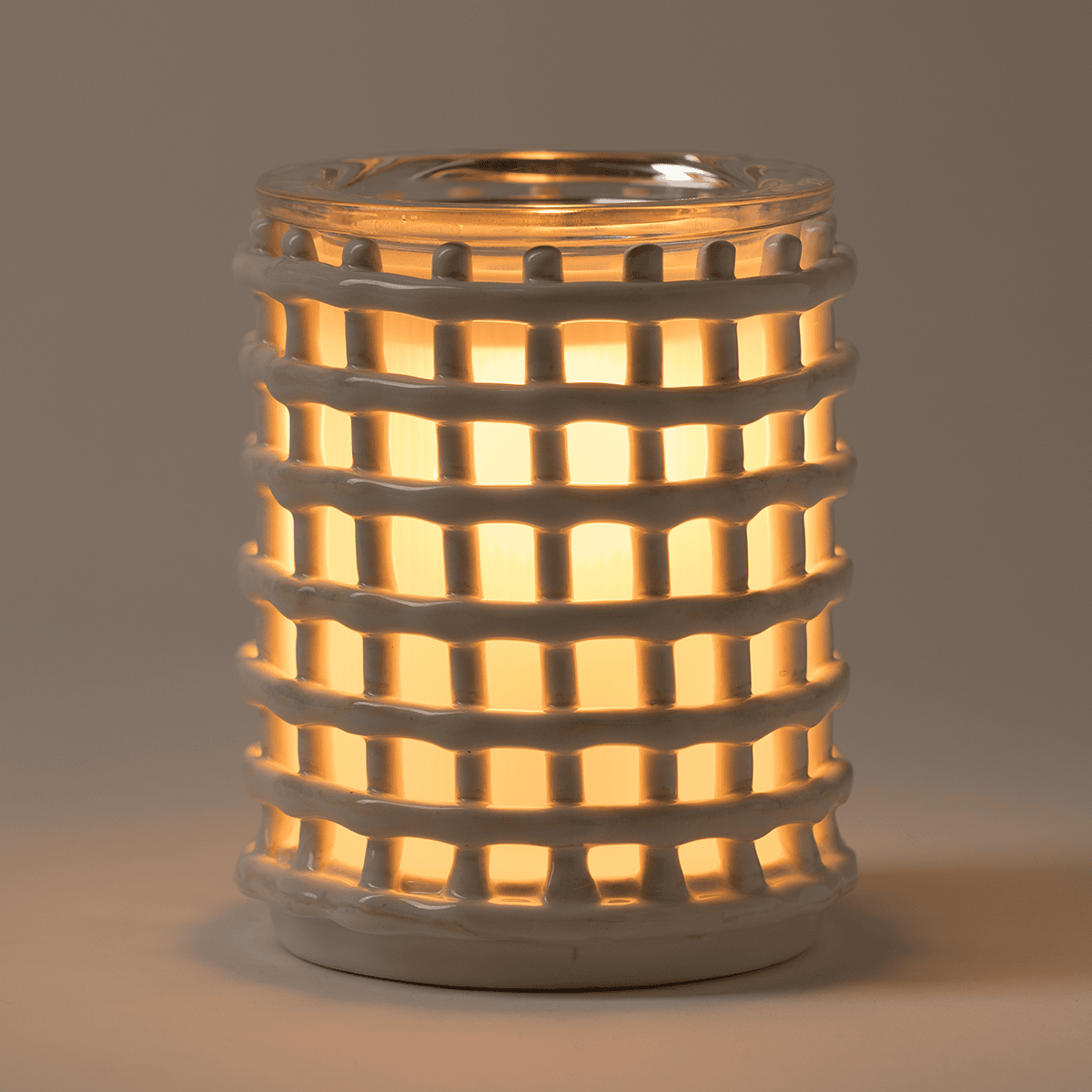 Cottage Weave Scentsy Warmer lit with soft amber glow highlighting woven texture in low light