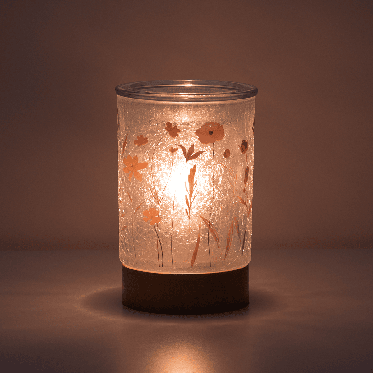 Pick of the Bunch Scentsy Warmer glowing softly in a dark room casting light
