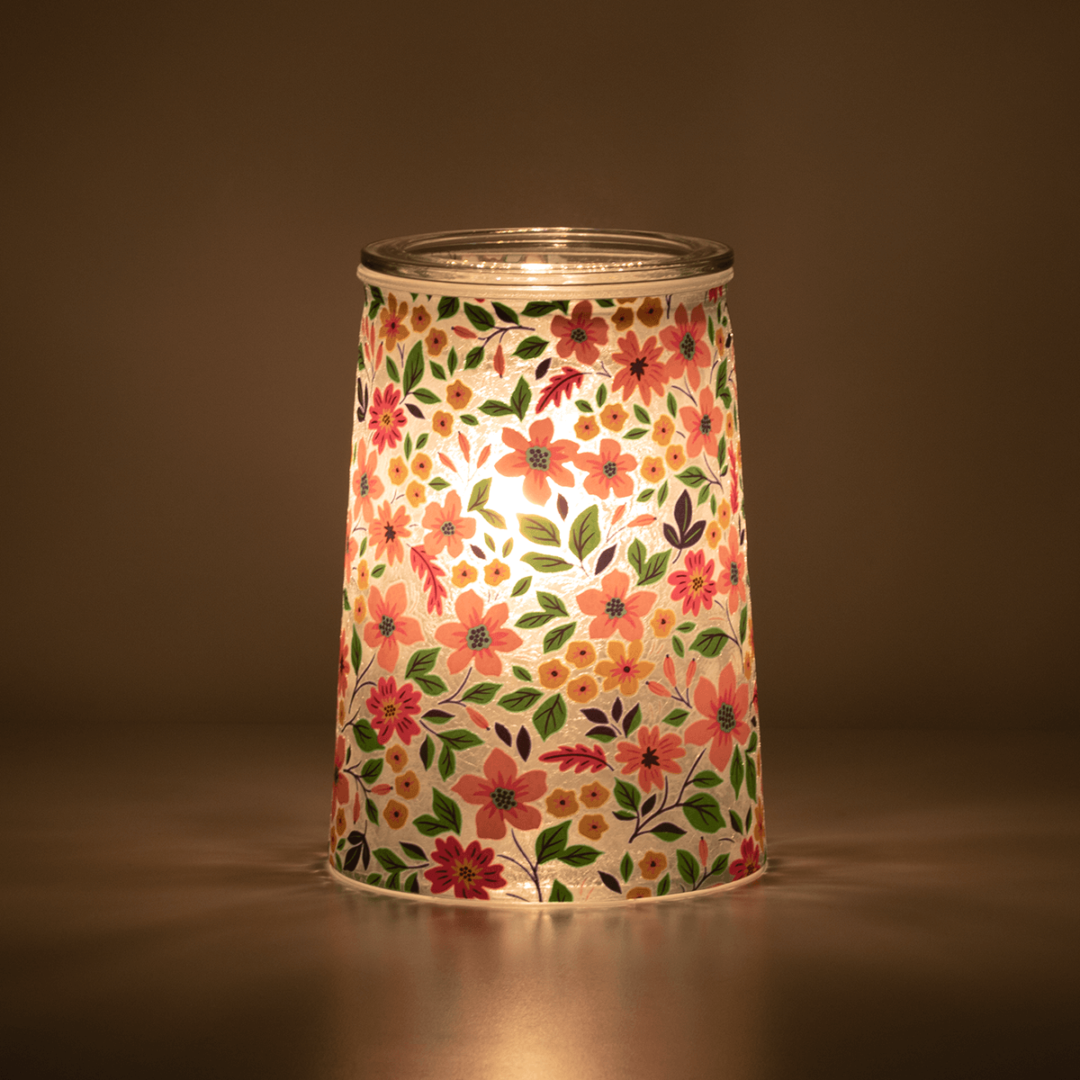Wildflower Scentsy Warmer glowing in a dark room with soft light