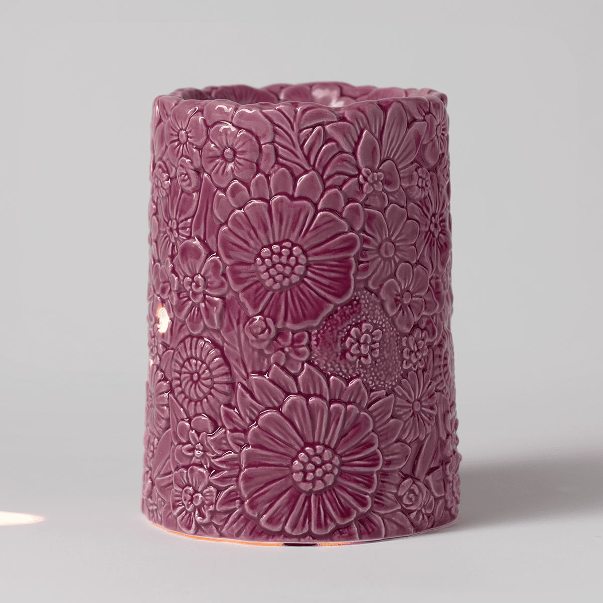Dusky Petals Scentsy Warmer softly glowing through carved floral details