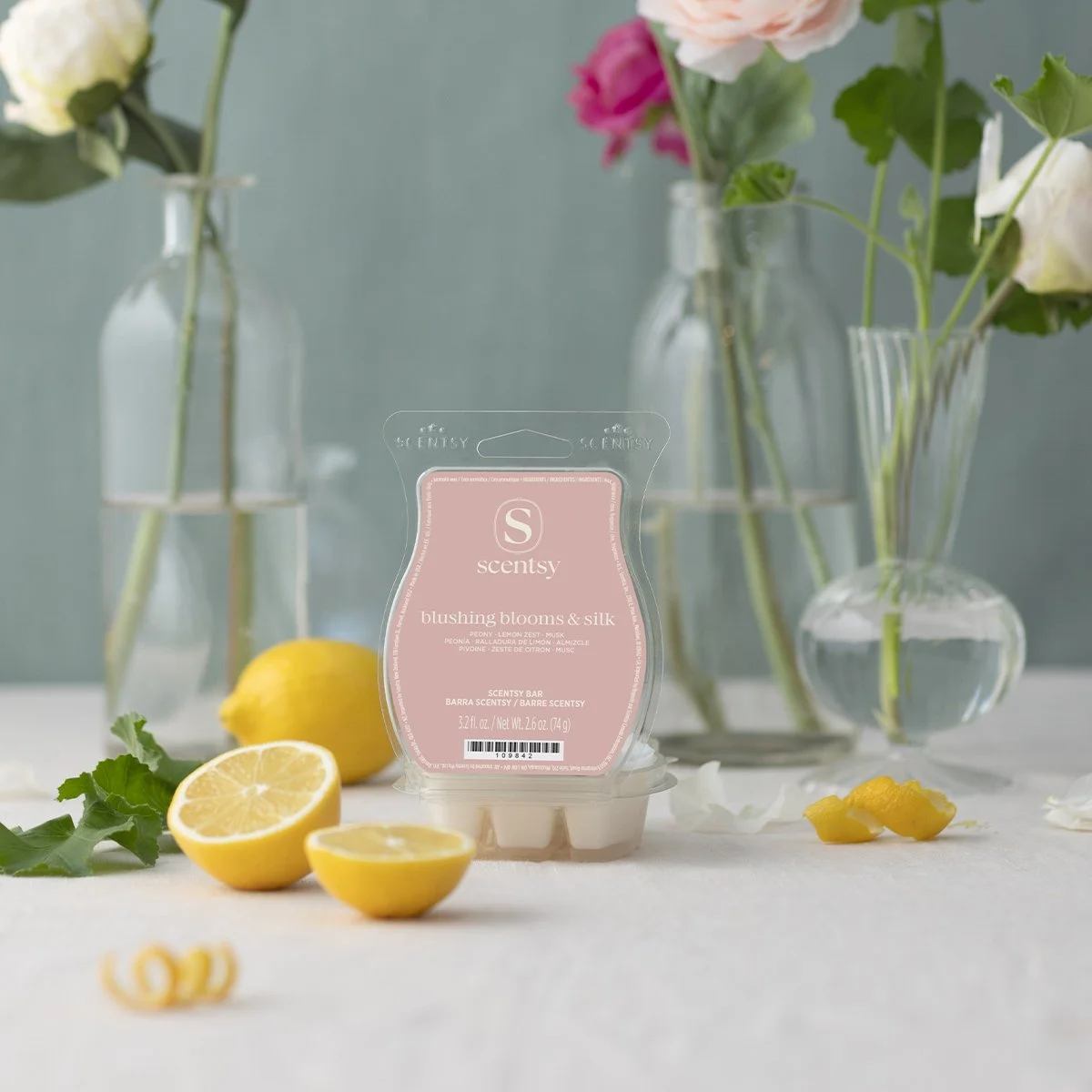 Blushing Blooms & Silk Scentsy Wax Bar styled with soft florals, lemon accents, and clear glass vases, offering a light and elegant take on a timeless floral fragrance