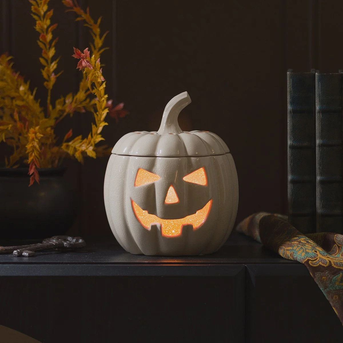 Jack’s Glow Scentsy Warmer glowing in a dark Halloween décor setting