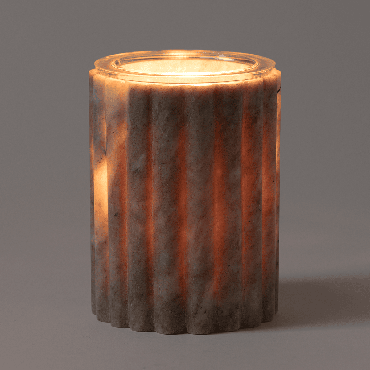 Morchana Marble Scentsy Warmer glowing softly on a bedside table, light filtering through natural marble