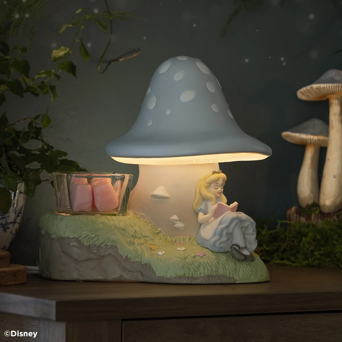 Disney Down the Rabbit Hole Scentsy Warmer displayed with pink wax cubes in a whimsical woodland setting