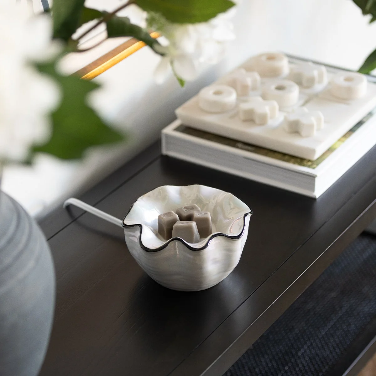 Lustra Scentsy element warmer styled on a table with neutral Inspire décor